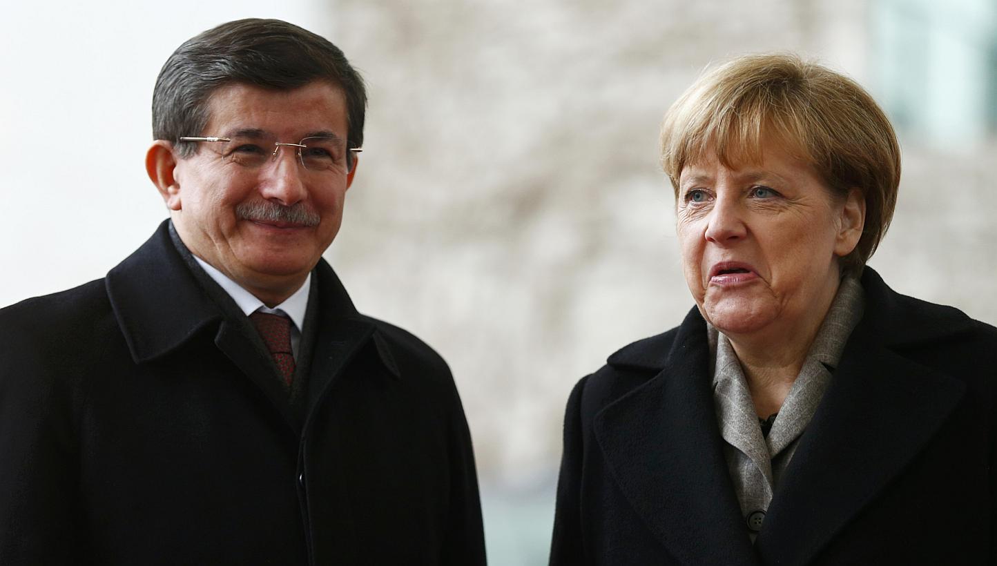 German Chancellor Angela Merkel reacts next to Turkish Prime Minister Ahmet Davutoglu during a welcoming ceremony in Berlin, on Jan 12, 2015. -- PHOTO: REUTERS