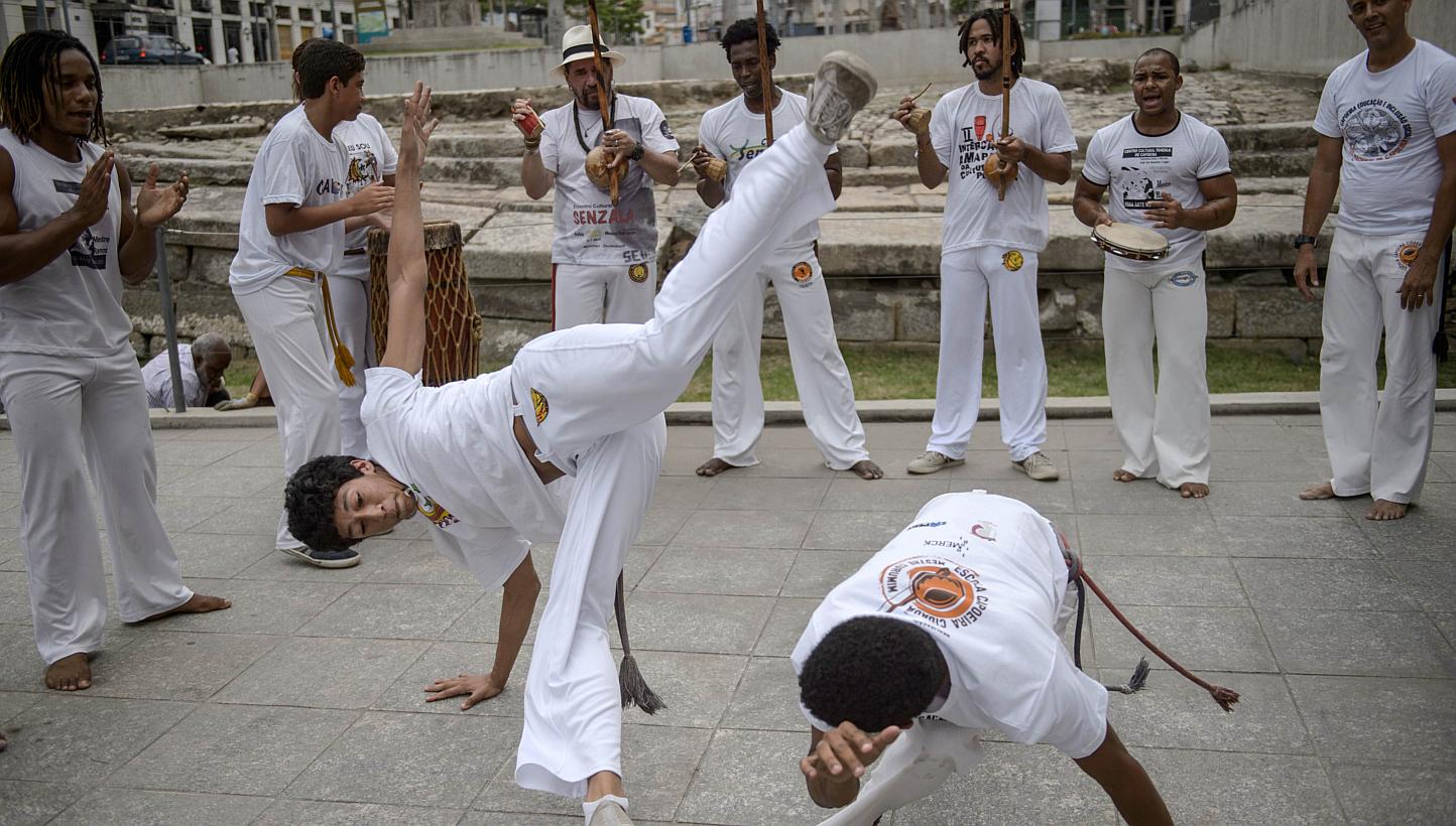 Players of Brazilian Capoeira, a mixture of dance and martial art inherited from the times of slavery, perform to celebrate the nomination of Capoeira to the list of UNESCO's Intangible Cultural Heritage in Rio de Janeiro, Brazil. --PHOTO: AFP