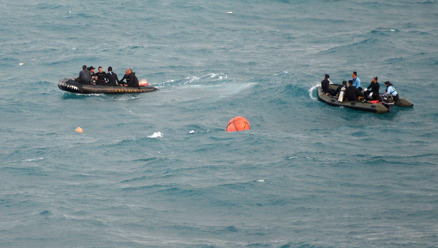 Indonesian Navy divers on Jan 10, 2015, waiting for the main team diving at a location (red buoy) where the tail section of AirAsia flight QZ8501 was found in the Java Sea during search operations. On Feb 16, 2015, the divers made a fresh bid to reac