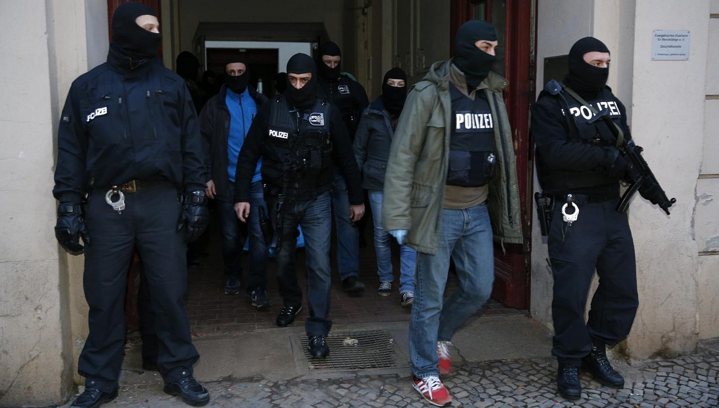 German special police units leave an apartment building in the Wedding district in Berlin on Jan 16, 2015. More than 200 German police officers raided suspected Islamist cells in and around Berlin early on Friday, arresting an alleged leader of