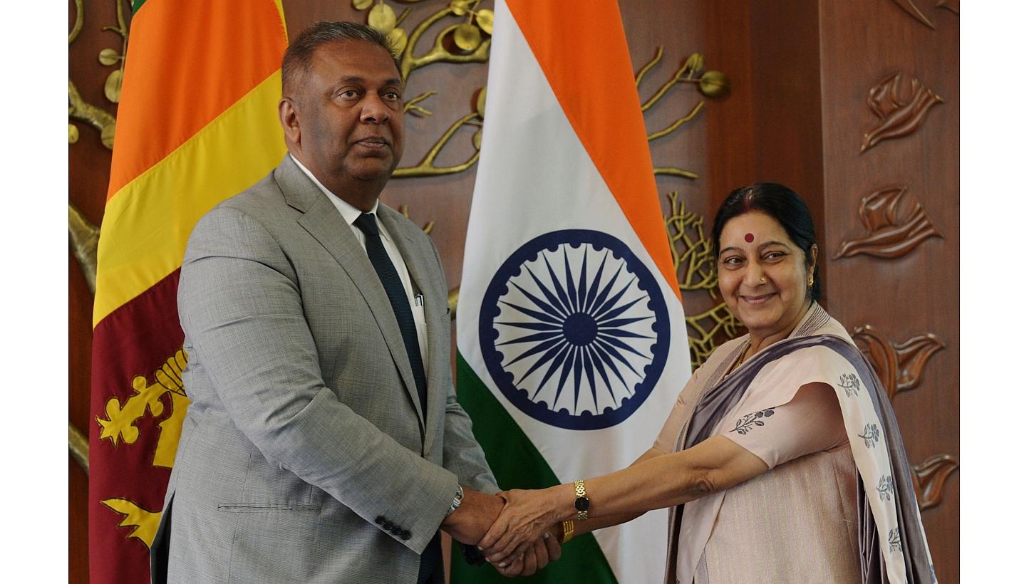 Sri Lankan Foreign Minister Mangala Samaraweera (left) and Indian Foreign Minister Sushma Swaraj shake hands before a meeting in New Delhi on Jan 18, 2015.&nbsp;Sri Lanka's new foreign ministermet his Indian counterpart in New Delhi on Sunday during 