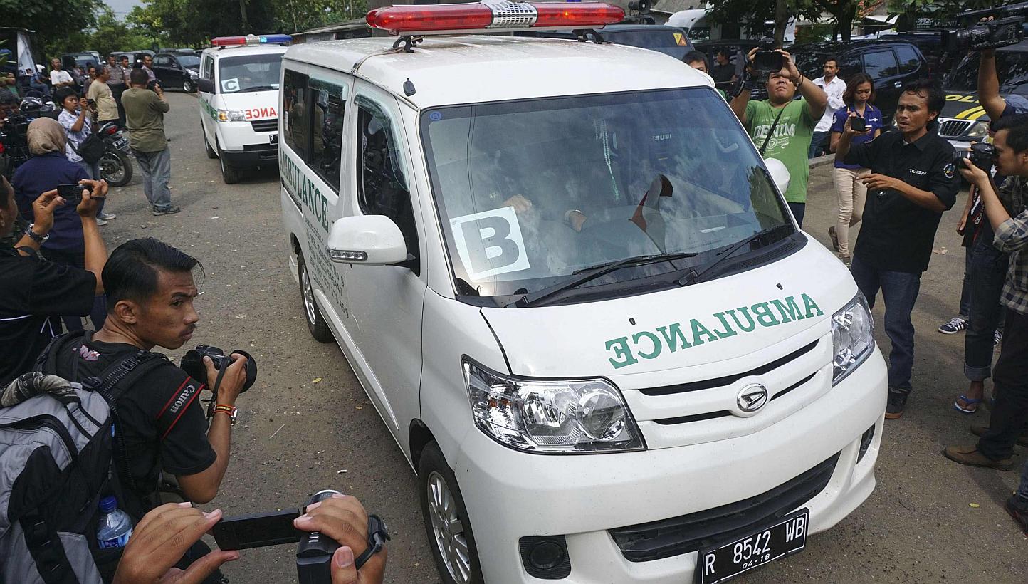 A convoy of ambulances carrying coffins make their way to Nusa Kambangan prison at Wijayapura quay, Cilacap, Central Java, on Jan 17, 2015. Indonesia on Sunday put to death six people convicted of drugs offences, including five foreigners, in the fir