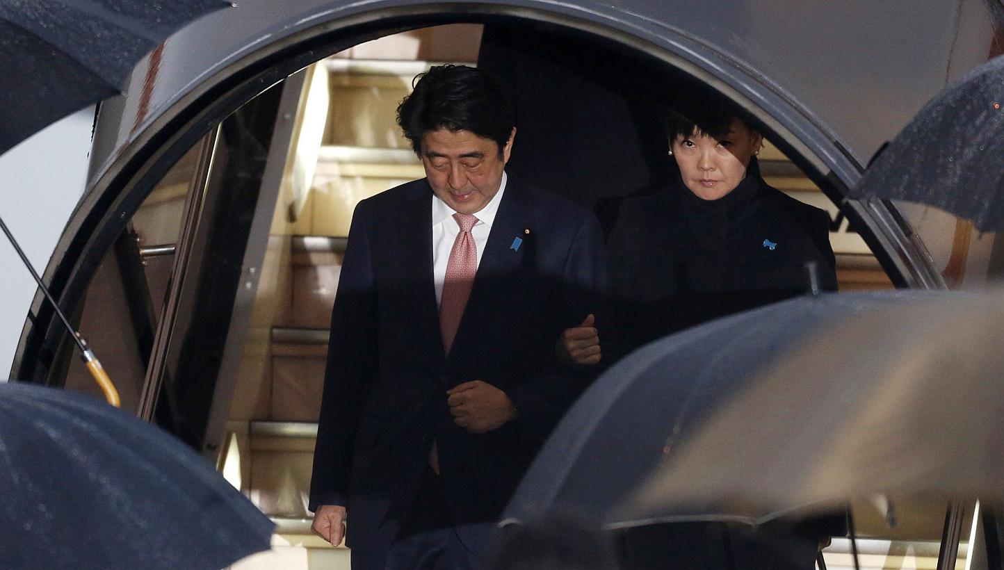 Japan's Prime Minister Shinzo Abe (left) and his wife Akie disembark from a plane as they arrive at Haneda airport in Tokyo on Jan 21, 2015. Mr Abe said on Wednesday the government was in a "race against time" to save two Japanese nationals held host