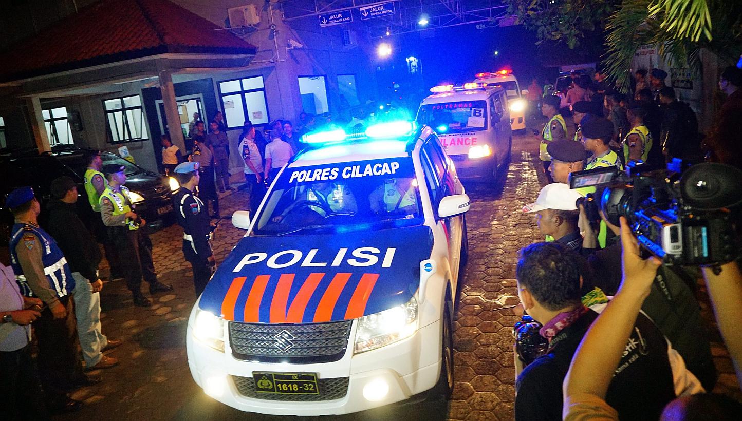 An Indonesian police car leads ambulances carrying five bodies of prisoners out of Wijayapura port as they arrived from Nusakambangan Island prison complex, after their execution under the death row for drug trafficking, in Cilacap, Central Java, Ind