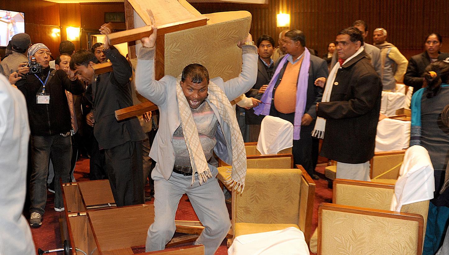 A Nepalese constituent assembly member breaks a chair as tensions flare at a Parliament session in Kathmandu on Jan 20, 2015. The country's Maoist chief apologised on Wednesday, Jan 21, for his party's part in the scuffle that injured four secur