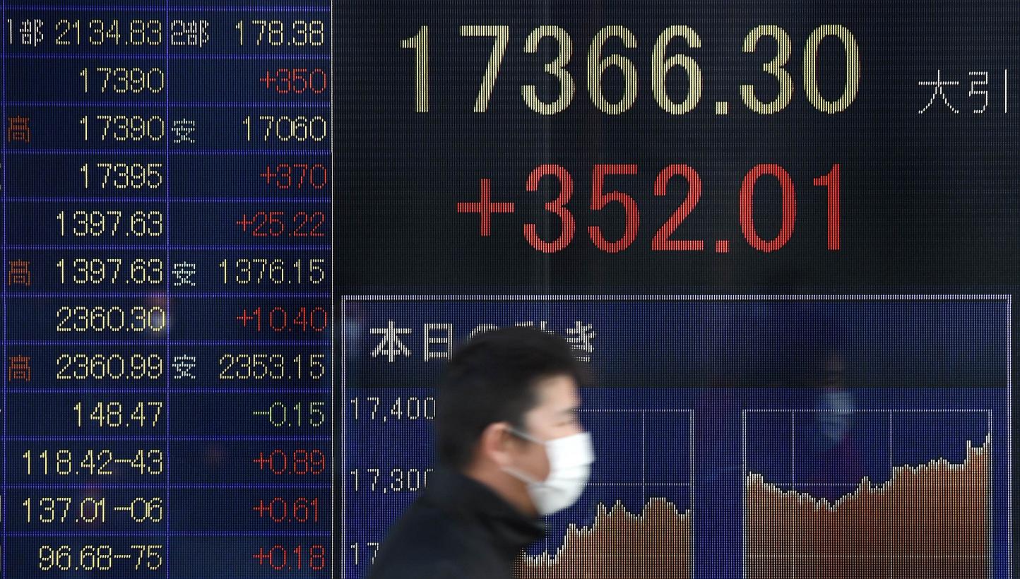 An electric quotation board flashing the Nikkei key index of the Tokyo Stock Exchange in front of a securities company in Tokyo on Jan 20, 2015. Asian shares held firm and the euro stayed under pressure on Wednesday as investors counted on the Europe