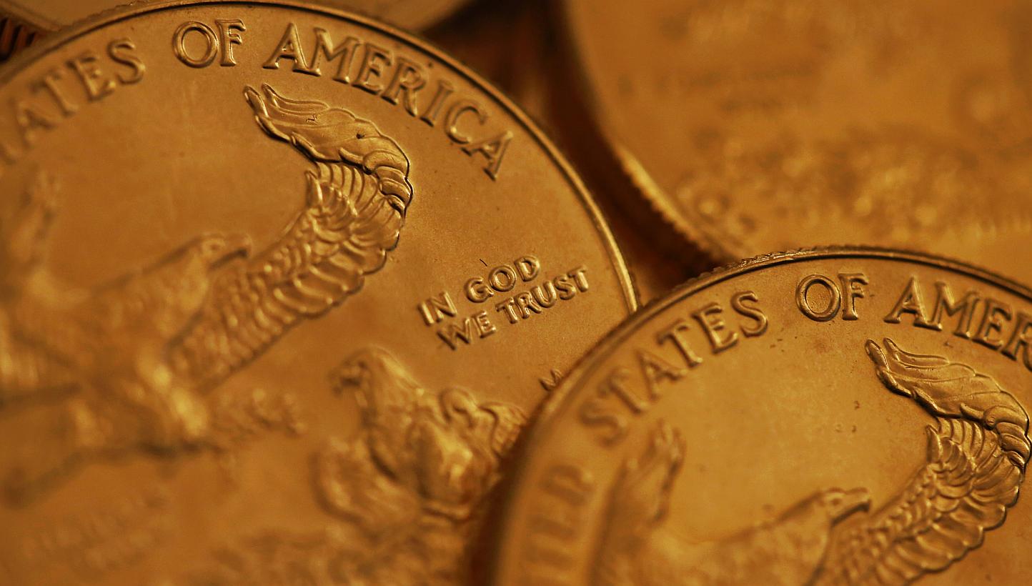 One ounce American gold coins in this arranged photograph. Gold has gained as investors assess the strength of the United States economy amid slumping oil prices. -- PHOTO: BLOOMBERG