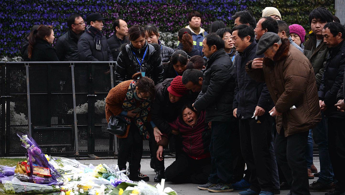 Family members mourning on Jan 6, 2015, for the victims of a new year's eve stampede at Shanghai's historic riverfront. -- PHOTO: AFP