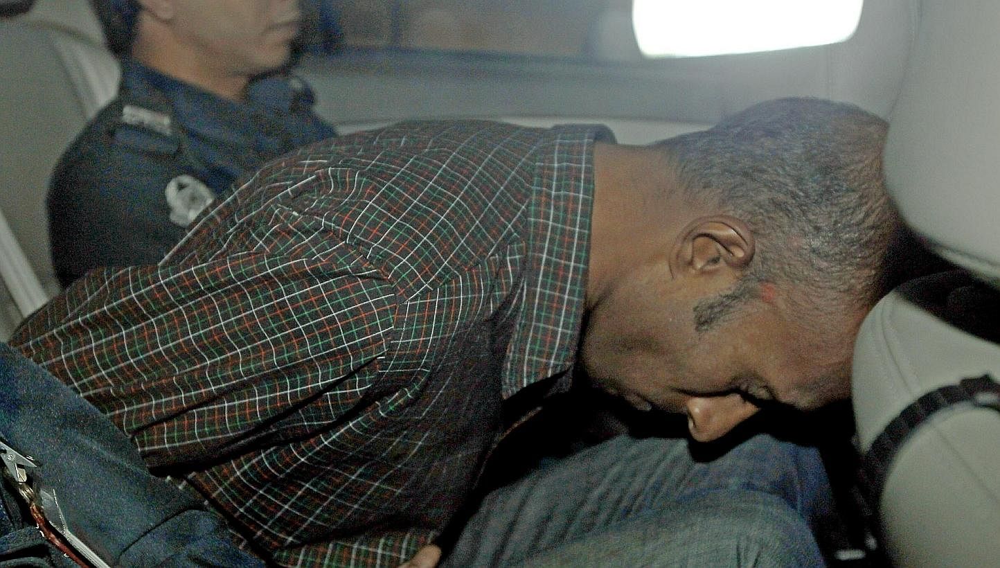James Raj Arokiasamy, accused of hacking into the Ang Mo Kio Town Council’s website, is being driven away after a court appearance on Nov 15, 2013. The alleged hacker pleaded guilty to 39 charges of computer misuse on Friday. -- ST PHOTO: WONG KWAI