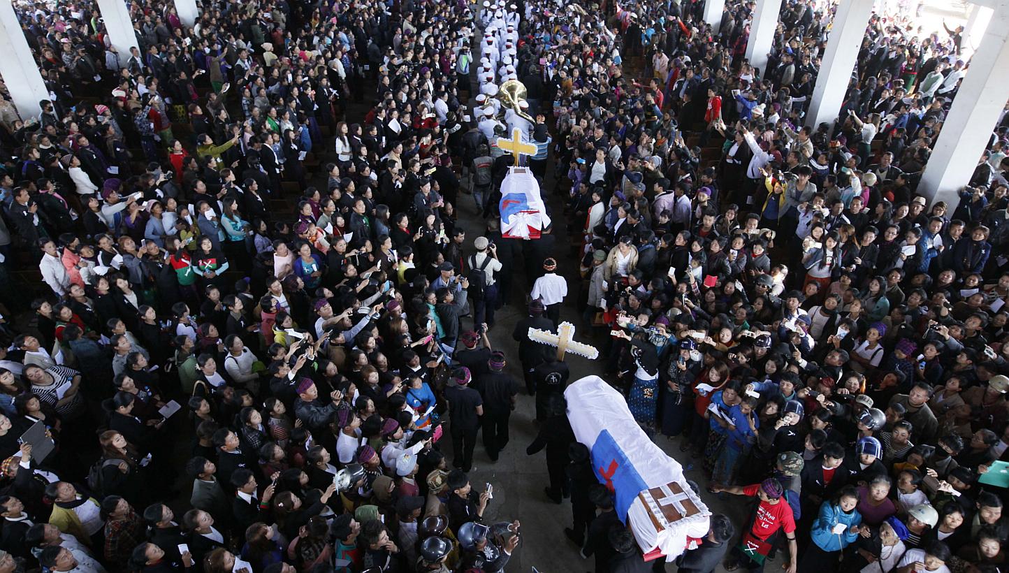 People attend a funeral service of two school teachers in Myitkyina, northern Myanmar on Jan 23, 2015. -- PHOTO: AFP
