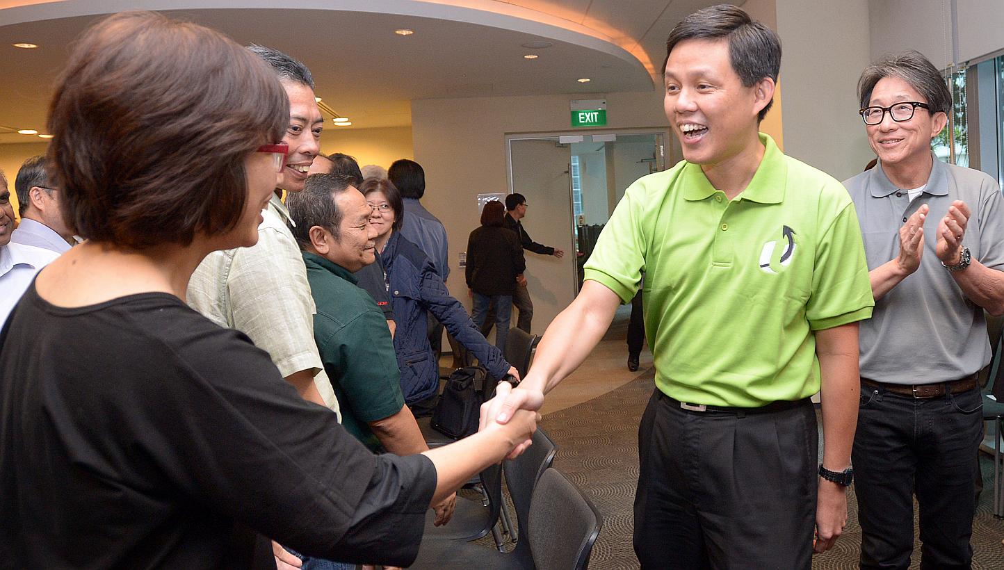 Mr Chan Chun Sing (centre), accompanied by Current NTUC secretary-general Lim Swee Say (right), greeting union leaders at NTUC Centre on Jan 23, 2015. -- ST PHOTO: LIM SIN THAI