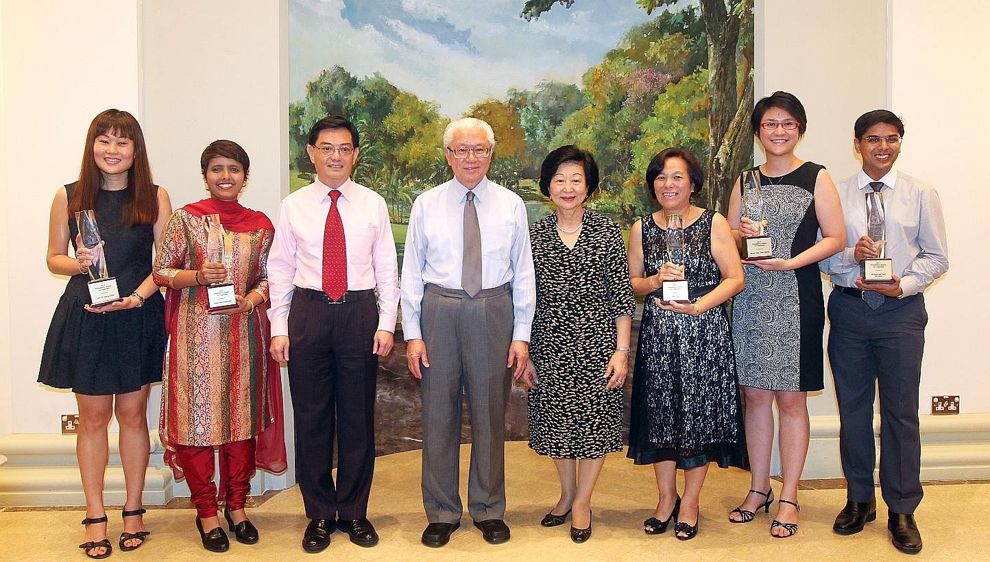 President Tony Tan Keng Yam (fourth from left) with his wife Mary (fourth from right) and Education Minister Heng Swee Keat (third from left) standing with President's Award for Teachers 2014 winners (from left) Linda Lim, Rezia Rahumathullah, Sim Lu