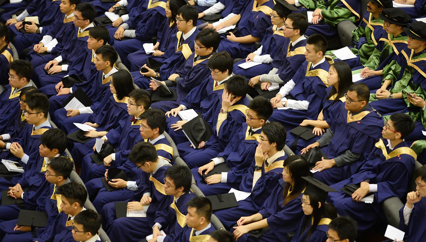 NUS graduates at their commencement ceremony in July 2014. -- ST PHOTO: MARK CHEONG