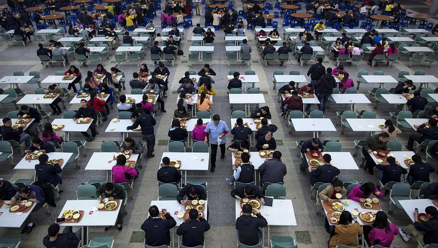 Workers eating their lunch at a restaurant inside a Foxconn factory in the township of Longhua in Shenzhen, Guangdong province on Jan 21, 2015. -- PHOTO: REUTERS