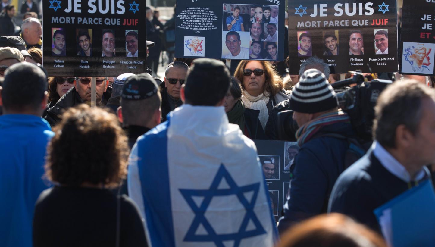 Mourners carry placards bearing portraits of the victims as they gather at a cemetery in Jerusalem on Jan 13, 2015 during the funeral of four Jews killed in an Islamist attack on a kosher supermarket in Paris. The number of anti-Semitic acts doubled