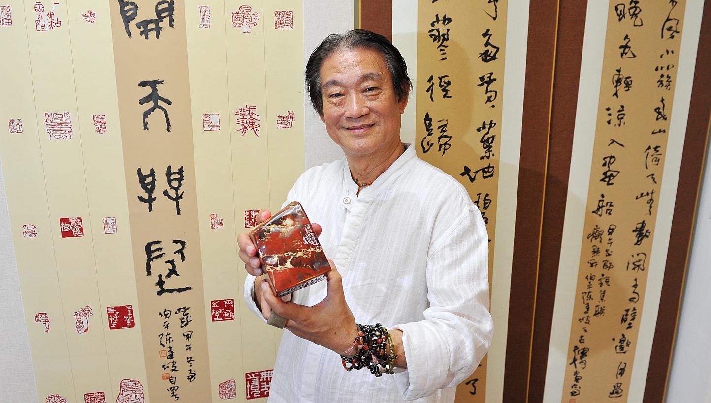 Singapore Chinese ink painter, calligrapher and seal carver Tan Kian Por is holding an exhibition which showcases seals carved on stones from Kluang, Malaysia. -- PHOTO: LIM YAOHUI FOR THE STRAITS TIMES