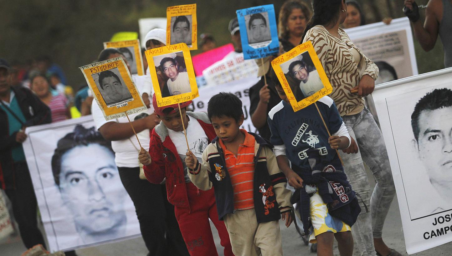 People carrying pictures of some of the 43 students who went missing in September in Mexico during a demonstration in&nbsp;Tixtla, on the outskirts of Chilpancingo, in the Mexican state of Guerrero, on Dec 7, 2014. -- PHOTO: REUTERS