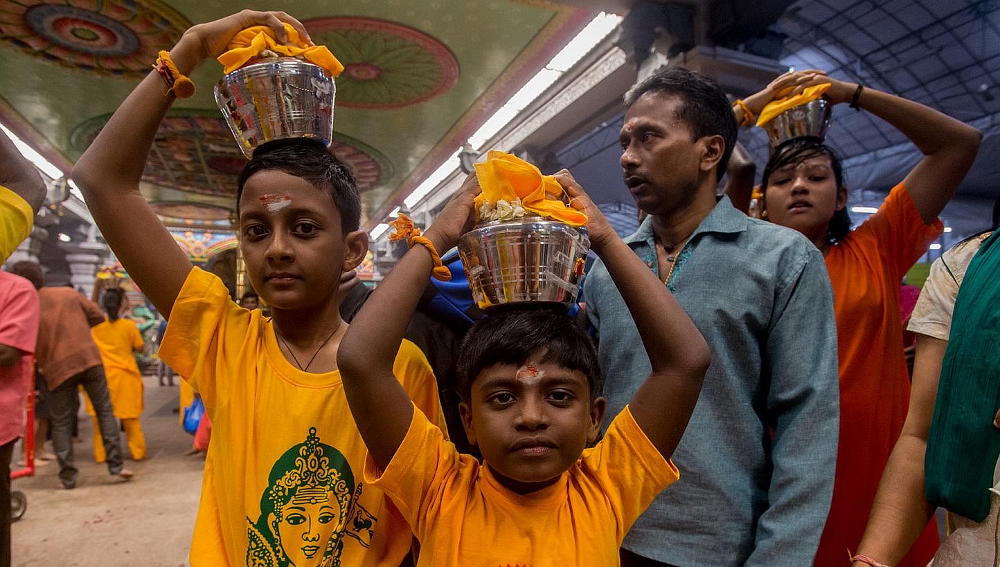 Children carrying palkudam during last year's Thaipusam procession. The annual Thaipusam Festival procession will begin at 12.05am on Feb 3 this year, the Hindu Endowments Board announced on Wednesday. -- PHOTO: TAMIL MURASU FILE&nbsp;