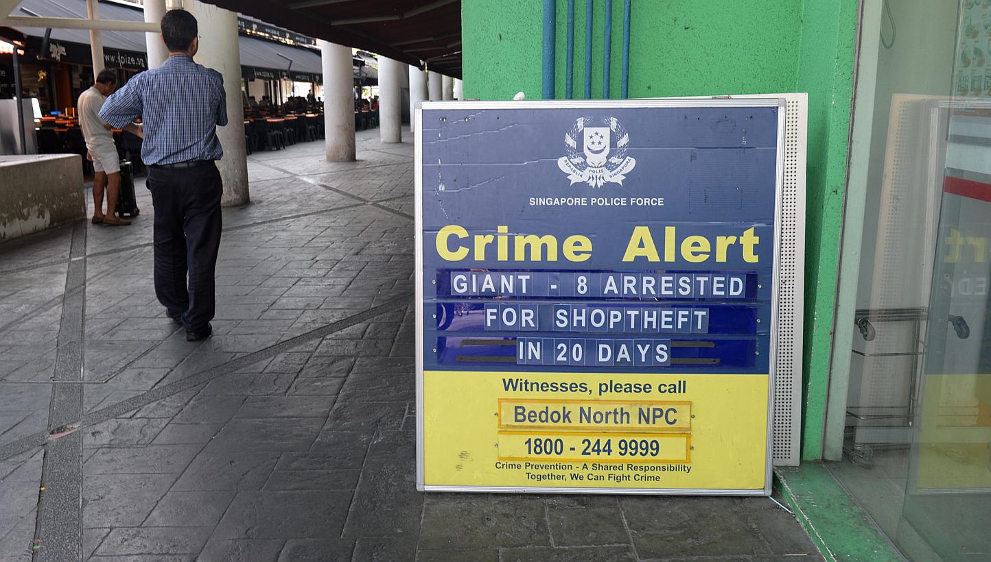 A crime alert sign put up by Neighbourhood Police Post (NPCCs) just outside Giant supermarket at Bedok Market Place on May 13, 2014. -- ST PHOTO: AZIZ HUSSIN