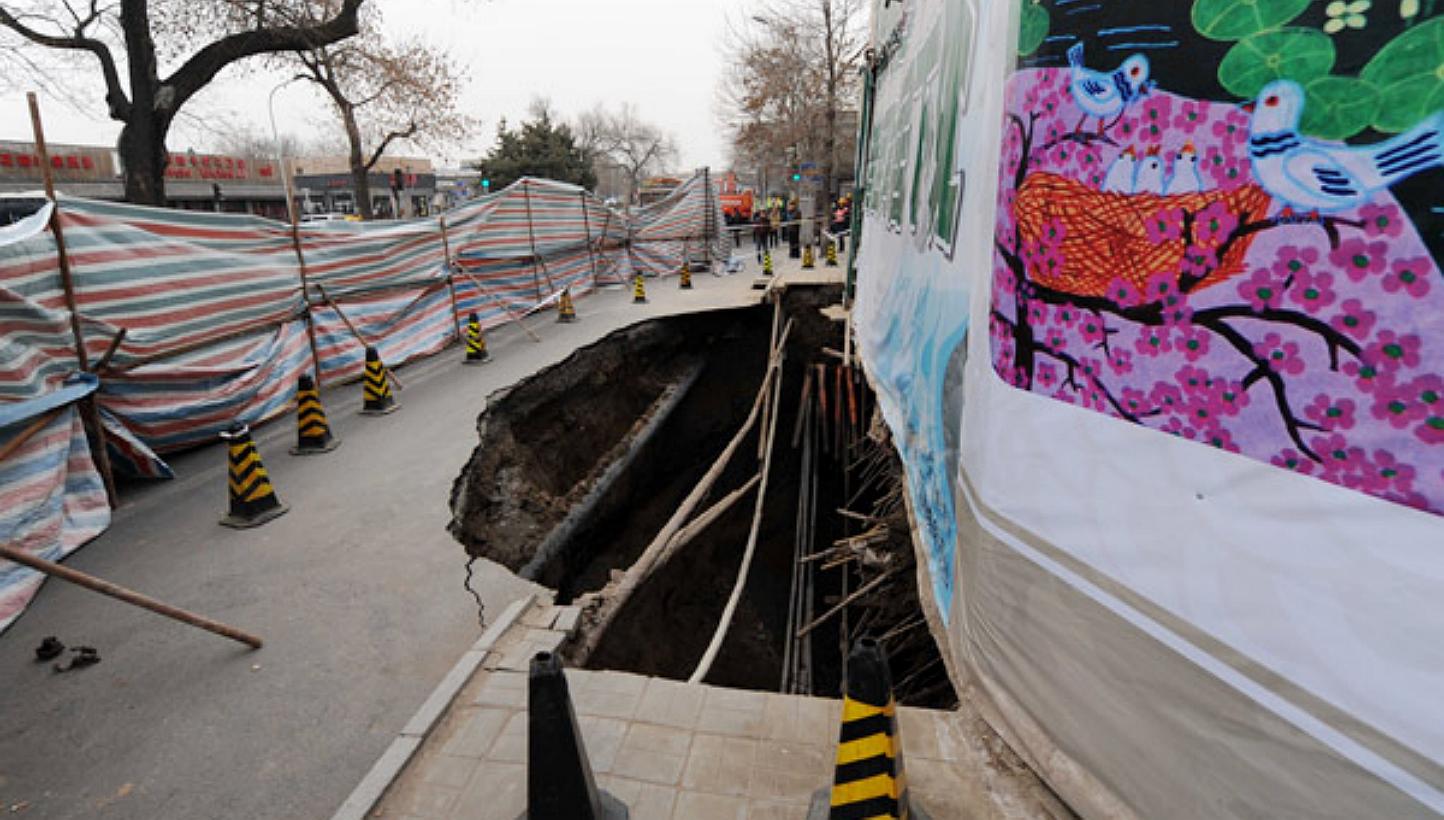 This photo taken on the morning of Saturday, Jan 24, 2015, shows a big hole on a street in Beijing's Xicheng district. The hole has since been filled in with 1,400 cu m of concrete. -- PHOTO: CHINA DAILY/ASIA NEWS NETWORK