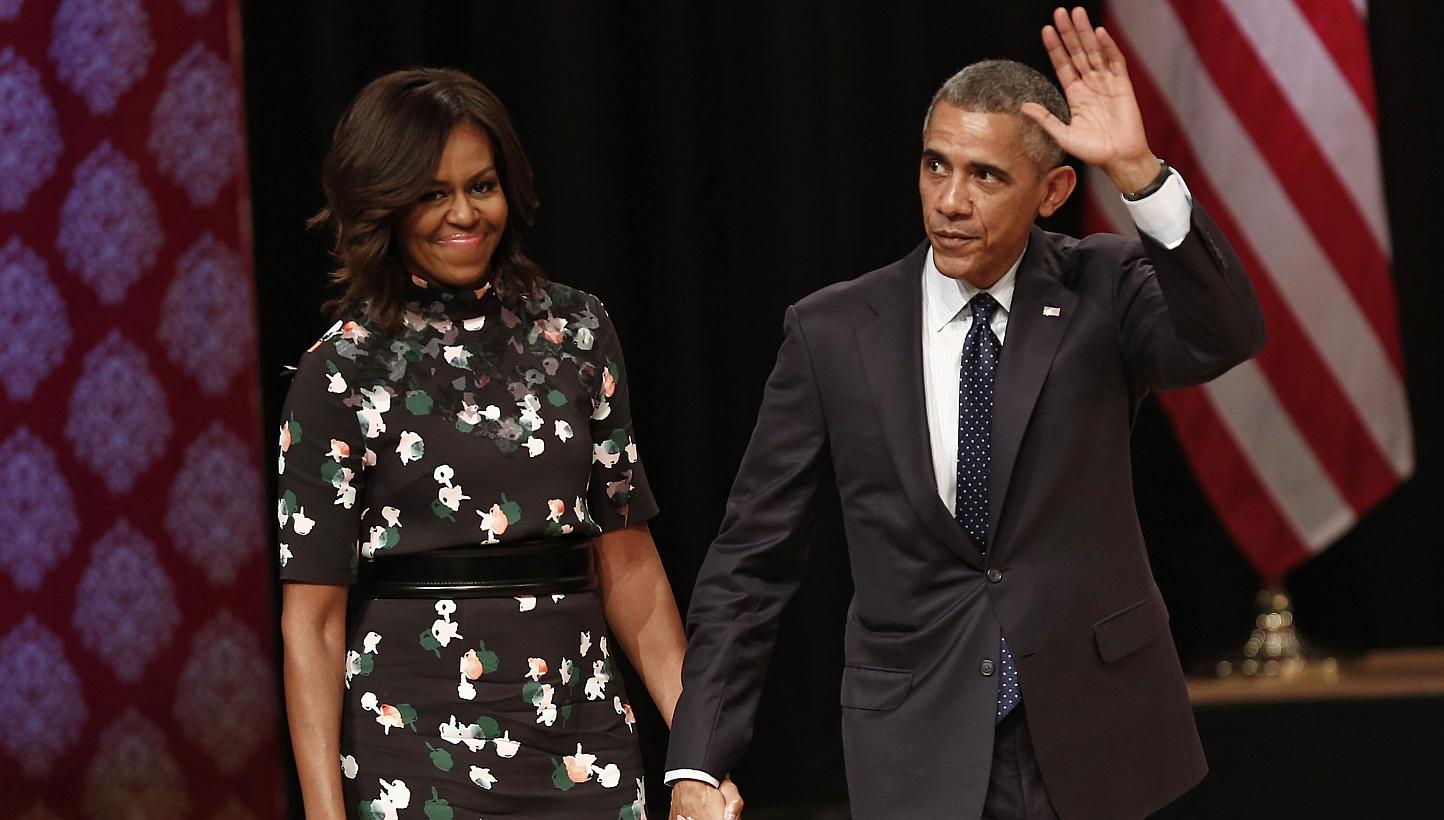US President Barack Obama waves as he walks with first lady Michelle Obama to greet the audience after he delivered a speech at Siri Fort Auditorium in New Delhi on Jan 27, 2015. -- PHOTO: REUTERS