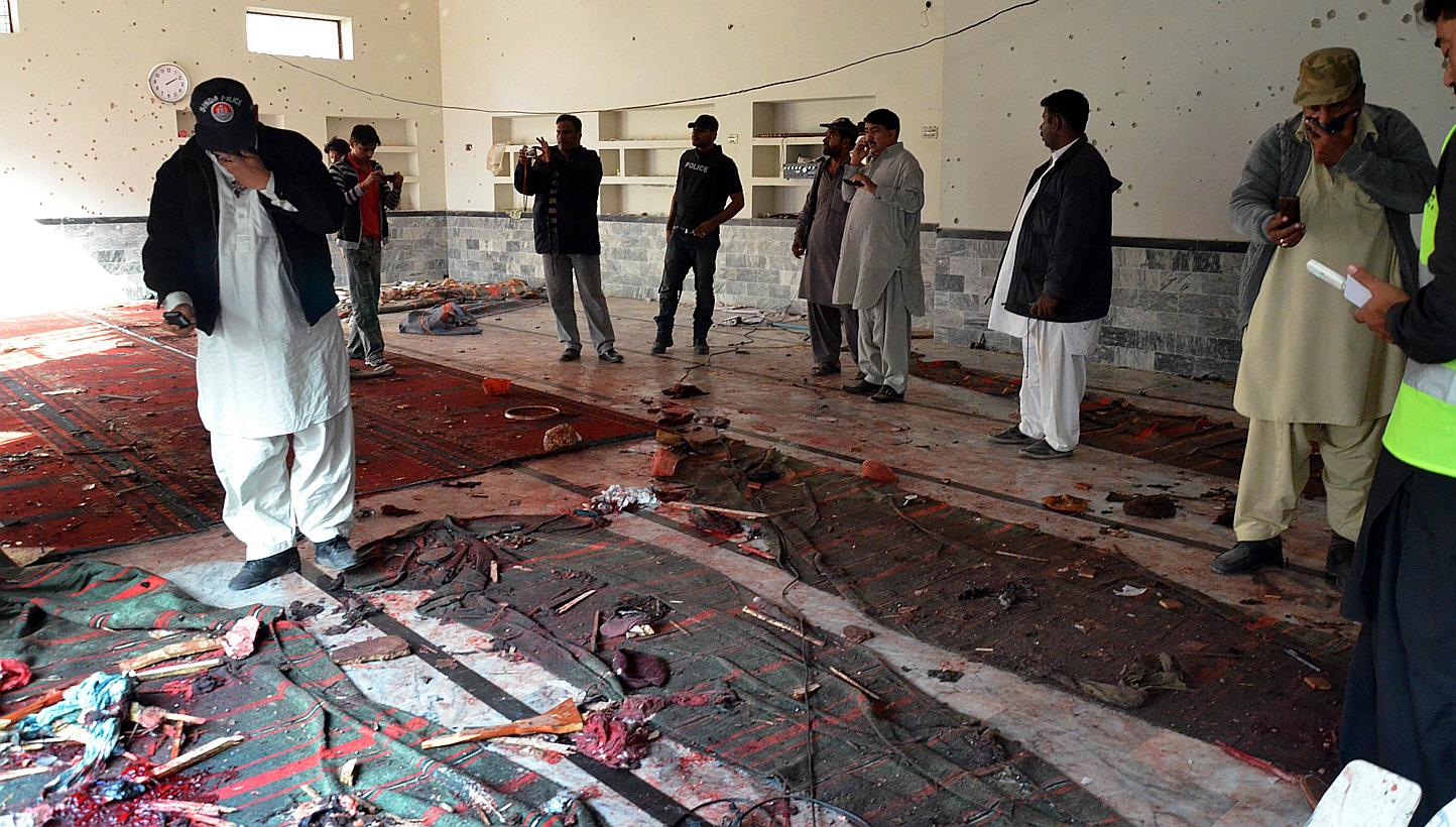 Pakistani security officials gather at a Shi'ite Muslim mosque after a bomb explosion in Shikarpur in Sindh province, around 470km north of Karachi on Jan 30, 2015. -- PHOTO: AFP