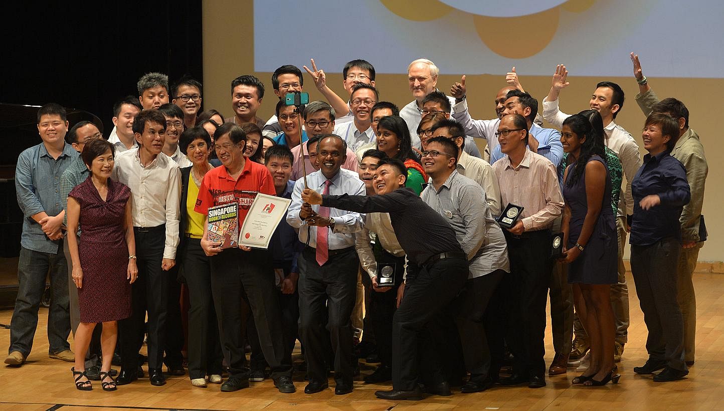 Minister K Shanmugam (front, with pink tie) takes part in a "we-fie" on stage as bone marrow donors set a Guinness record for the largest number of bone marrow donors in the same place at the Raffles Institution on Jan 30, 2015. -- ST PHOTO: ALPHONSU