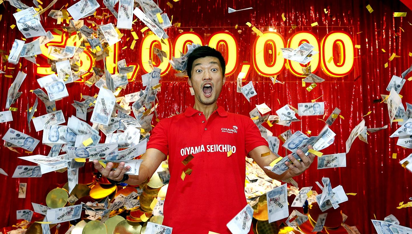 Japanese civil engineer Oiyama Seiichiro, 34, walked away with $1 million after he won Changi Airport's millionaire draw on Sunday, Feb 1, 2015. -- ST PHOTO: CHEW SENG KIM