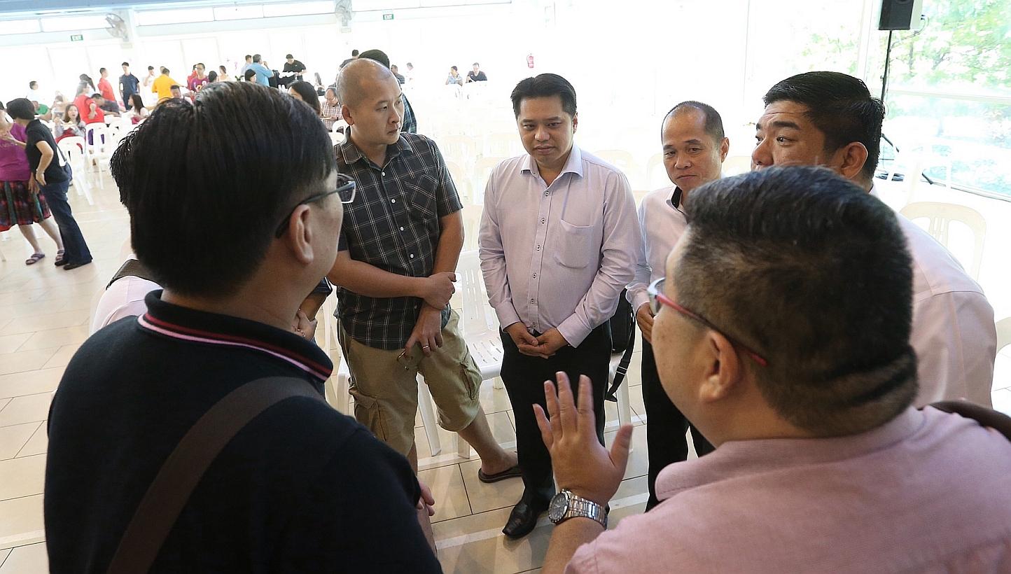 Chief executive of Life Corp Simon Hoo (centre) speaks to residents after the residents' dialogue session on Jan 4, 2015. -- ST PHOTO: NEO XIAOBIN