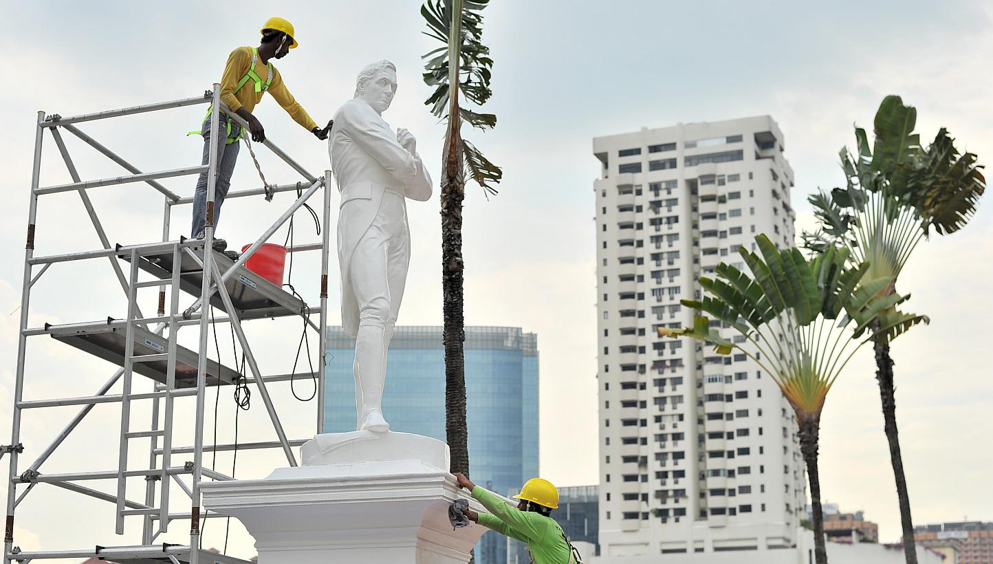 The statue of Sir Stamford Raffles being cleaned in 2014. -- PHOTO: ST FILE