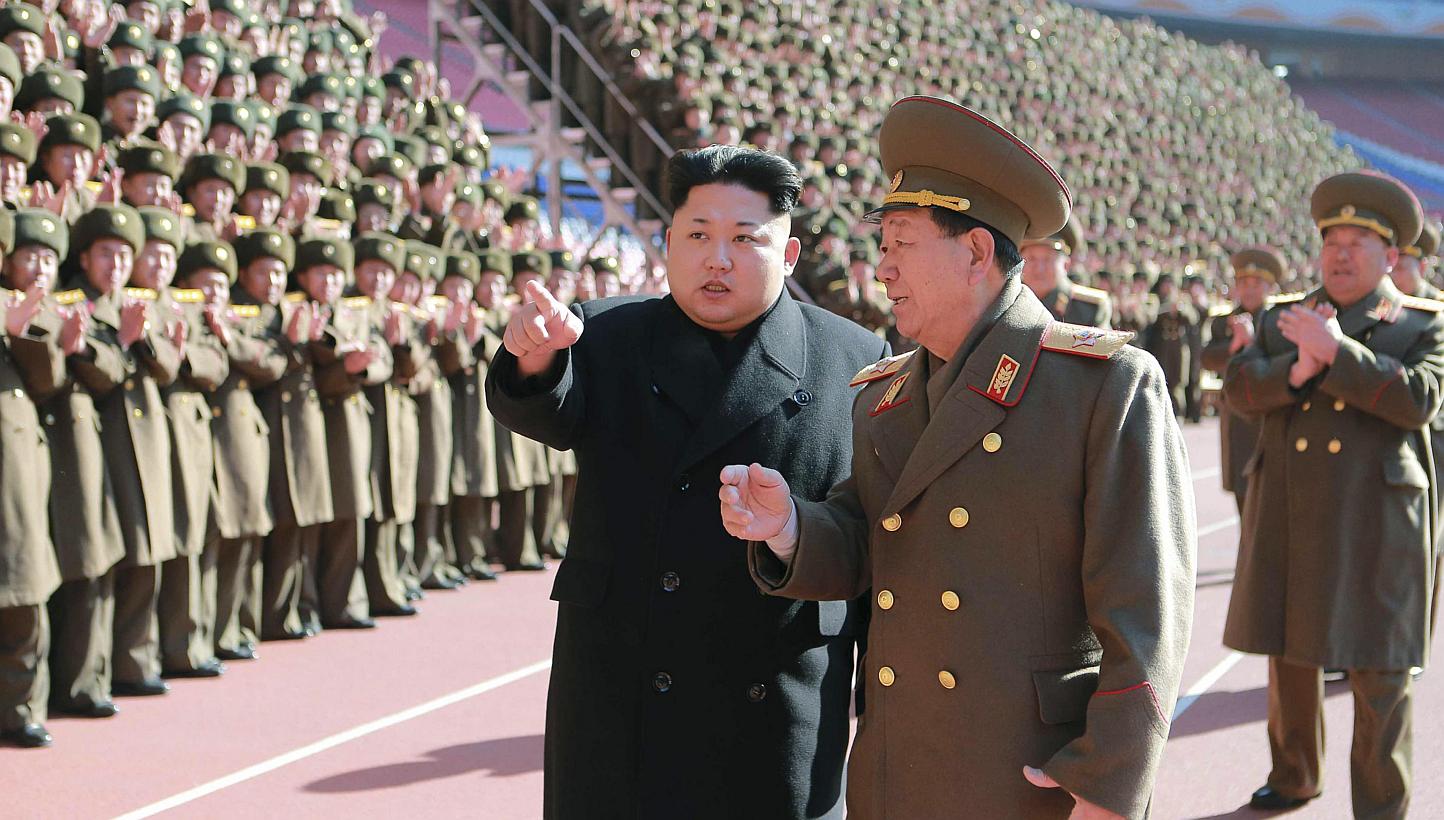 North Korean leader Kim Jong Un (centre) gesturing during a photo session at a meeting of military and political cadres in this undated photo released by North Korea's Korean Central News Agency in Pyongyang on Feb 2, 2015. -- PHOTO: REUTERS