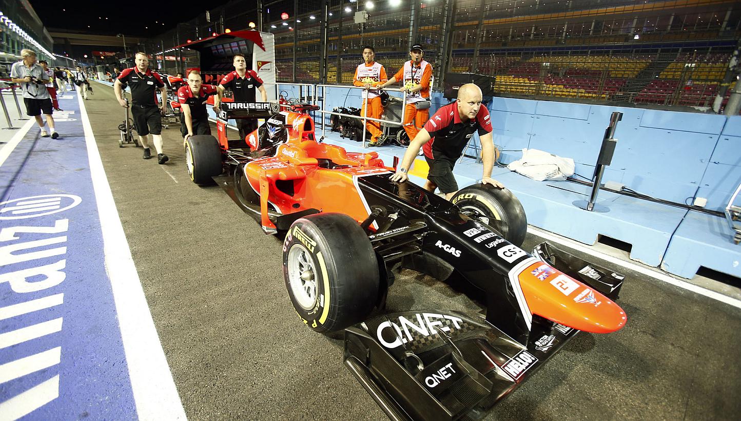 The Marussia F1 team push their car out of the garage, a day before the SingTel Singapore Grand Prix 2012 Formula One practice session, at the F1 pit building on Singapore's Marina Bay Circuit on Sep 20, 2012.&nbsp;The troubled F1 team could start th