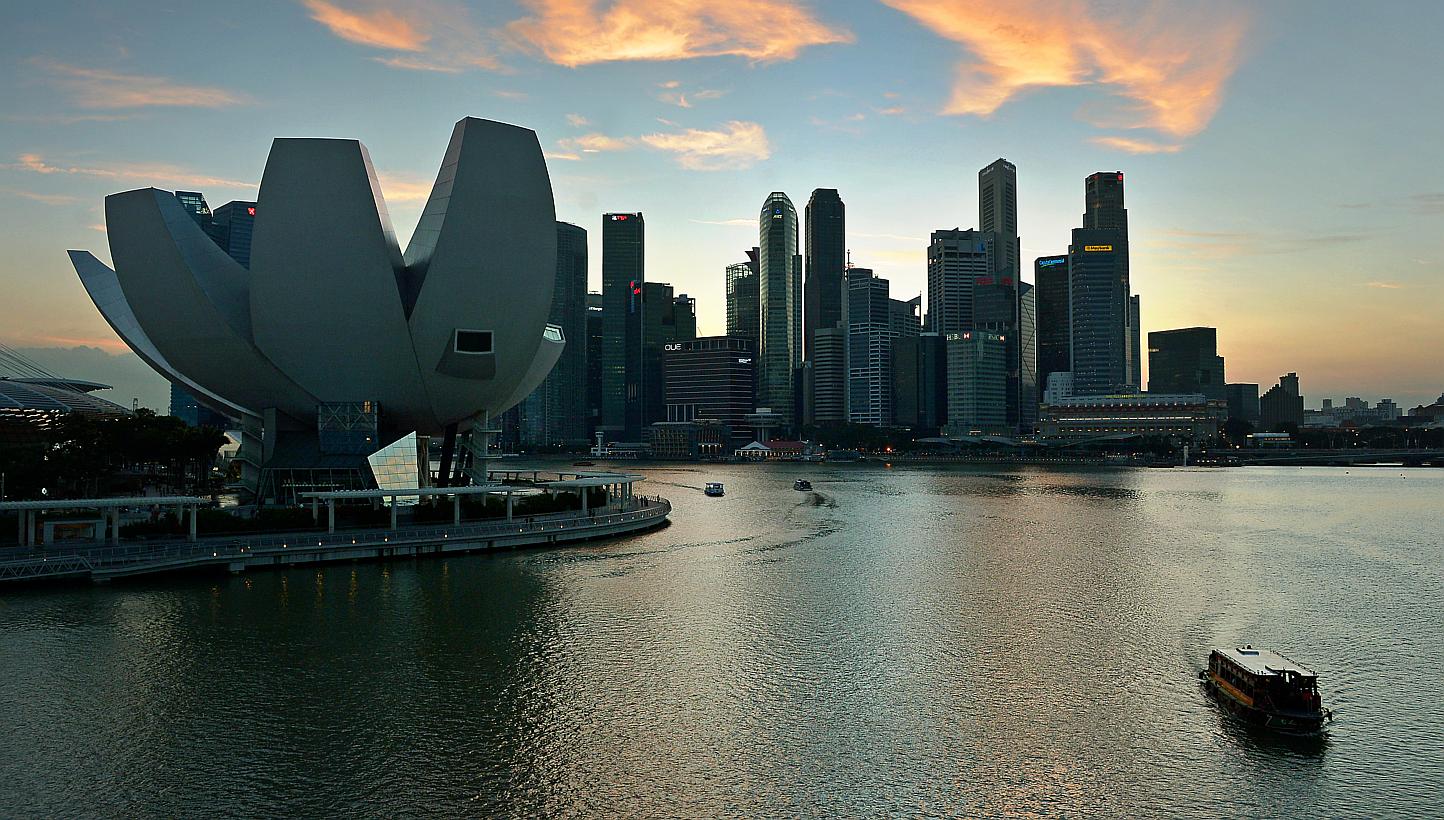 Bumboats travelling on Marina Bay with the skyline of the ArtScience Museum (left) and the Marina Bay financial district as the background. -- PHOTO: ST FILE
