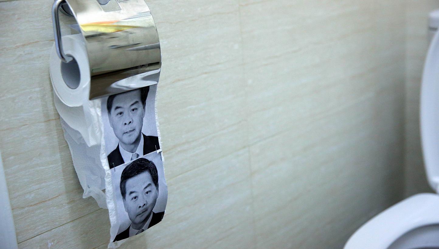 This photo taken on Dec 23, 2014 shows novelty toilet paper with the image of Hong Kong's Chief Executive Leung Chun-ying (right) in a flat turned into a recreation of the main pro-democracy protest site in Hong Kong. -- PHOTO: AFP