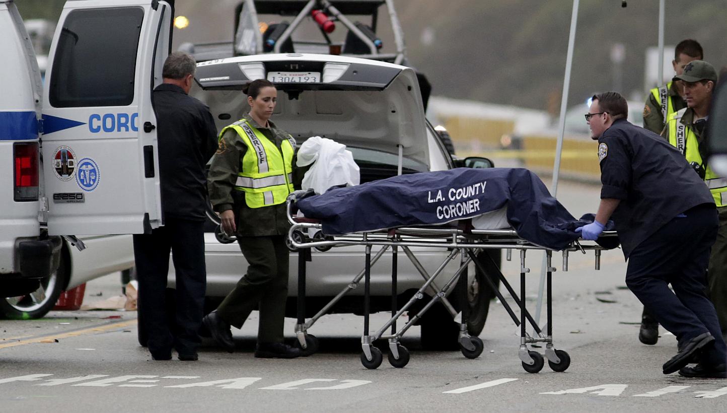 A Los Angeles County coroner worker loading a victim into a van at the scene of a four-car crash involving Olympic gold medalist and reality TV star Bruce Jenner in Malibu, California on Feb 7, 2015.&nbsp;-- PHOTO: REUTERS