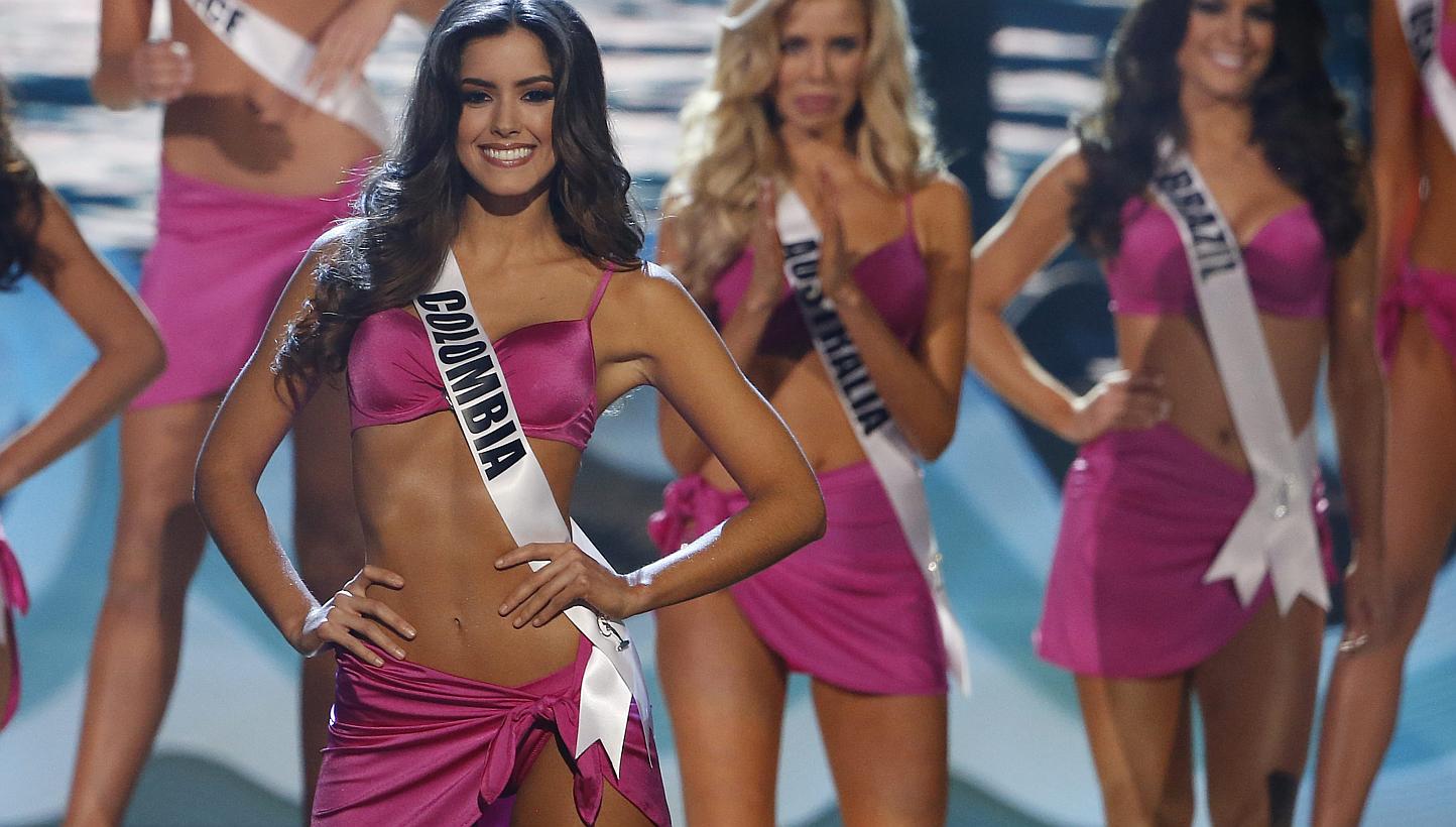 Colombia's Marxist Farc rebels have invited the newly-crowned Miss Universe Paulina Vega (above left), a native of the country's Caribbean coast, to attend their peace negotiations with the government, a bid to end 50 years of fighting. -- PHOTO: EPA