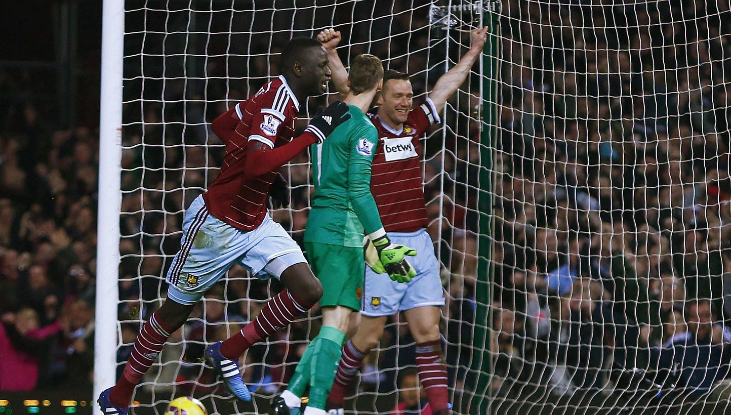 West Ham United's Cheikhou Kouyate (left) celebrates after scoring a goal against Manchester United during their English Premier League soccer match at the Boleyn Ground in London on Sunday. -- PHOTO: REUTERS
