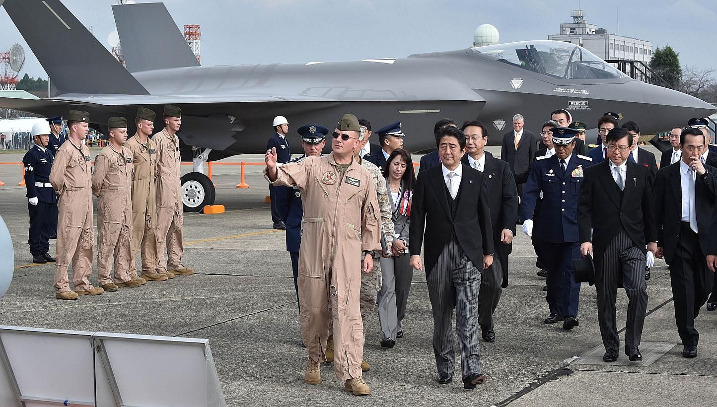 Japanese Prime Minister Shinzo Abe at a review ceremony at the Self-Defence Forces' Hyakuri air base in Ibaraki prefecture last October. The country's defence budget for this year is set to cover state-of-the-art military acquisitions, including F-35