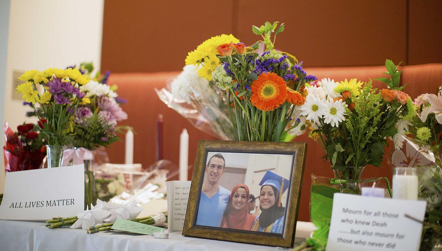 A makeshift memorial for Mr Deah Shaddy Barakat, his wife Yusor Mohammad and Yusor's sister Razan Mohammad Abu-Salha, who were killed by a gunman, is pictured inside of the University of North Carolina School of Dentistry, in Chapel Hill, North Carol