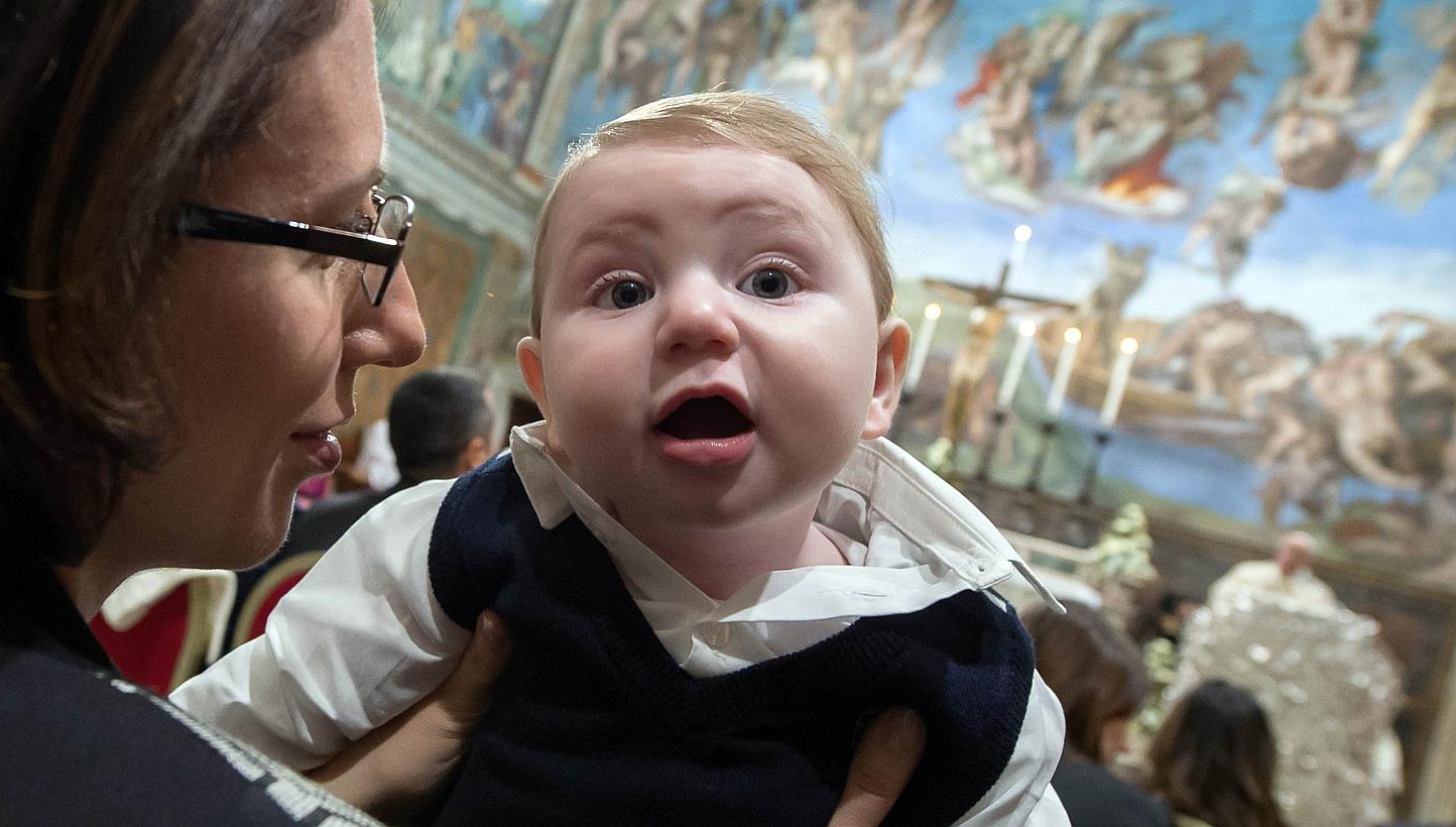 A woman holding a baby at the Vatican on&nbsp;Jan 11, 2015, as Pope Francis delivers a speech.&nbsp;Fewer babies were born in Italy in 2014 than in any other year since the modern Italian state was formed in 1861, new data shows, highlighting the dem