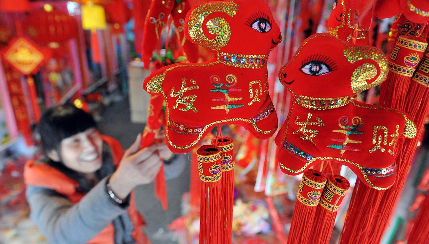 A customer buying decorations for the upcoming Lunar New Year in Lin'an, Zhejiang province, on Feb 12, 2015. -- PHOTO: AFP
