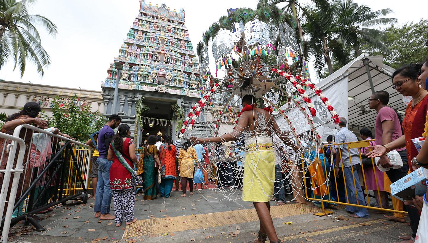 Devotees in a procession before entering Sri Thendayuthapani Temple - the end point - on Tank Road. -- ST PHOTO: ONG WEE JIN