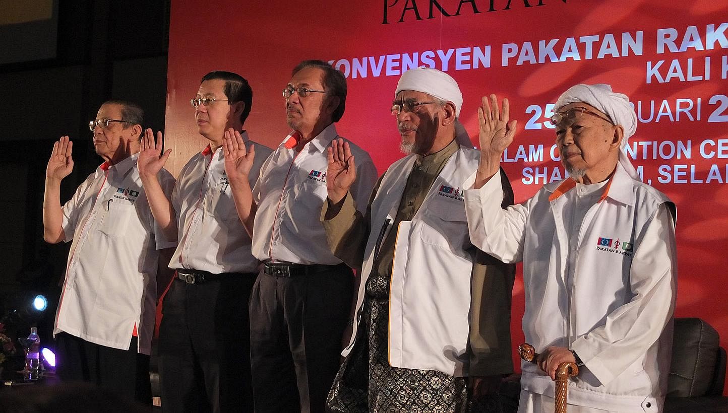 Opposition leaders (from left) Lim Kit Siang, Lim Guan Eng, Anwar Ibrahim, Abdul Hadi Awang and Nik Aziz Nik Mat taking the coalition oath at the Pakatan Rakyat convention and manifesto launch on Feb 25 2013. ST FILE PHOTO