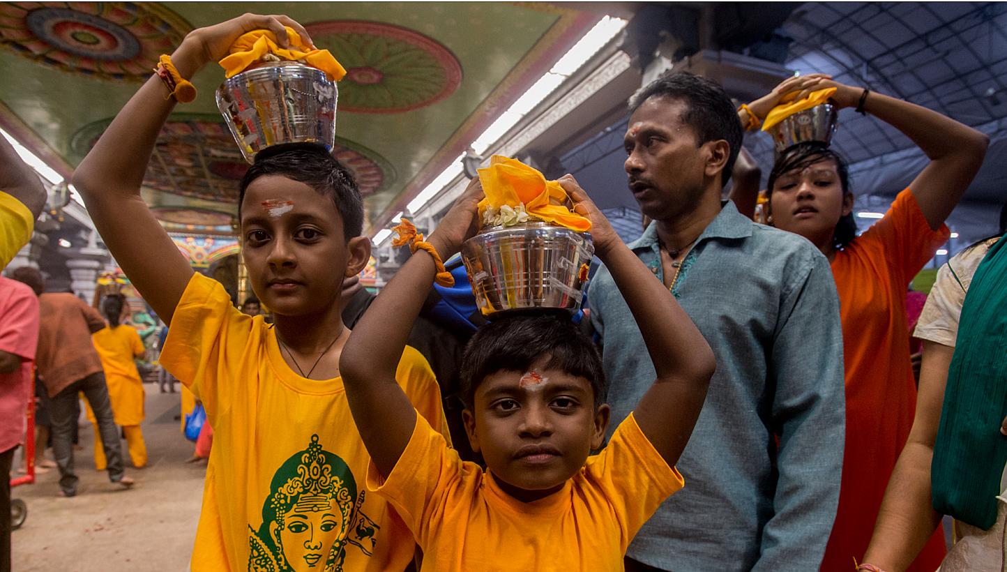 Young children carrying palkudam during the Thaipusam procession on Jan 17, 2014. The Ministry of Manpower (MOM) has issued a response on whether Thaipusam should be reinstated as a public holiday. -- PHOTO: TAMIL MURASU