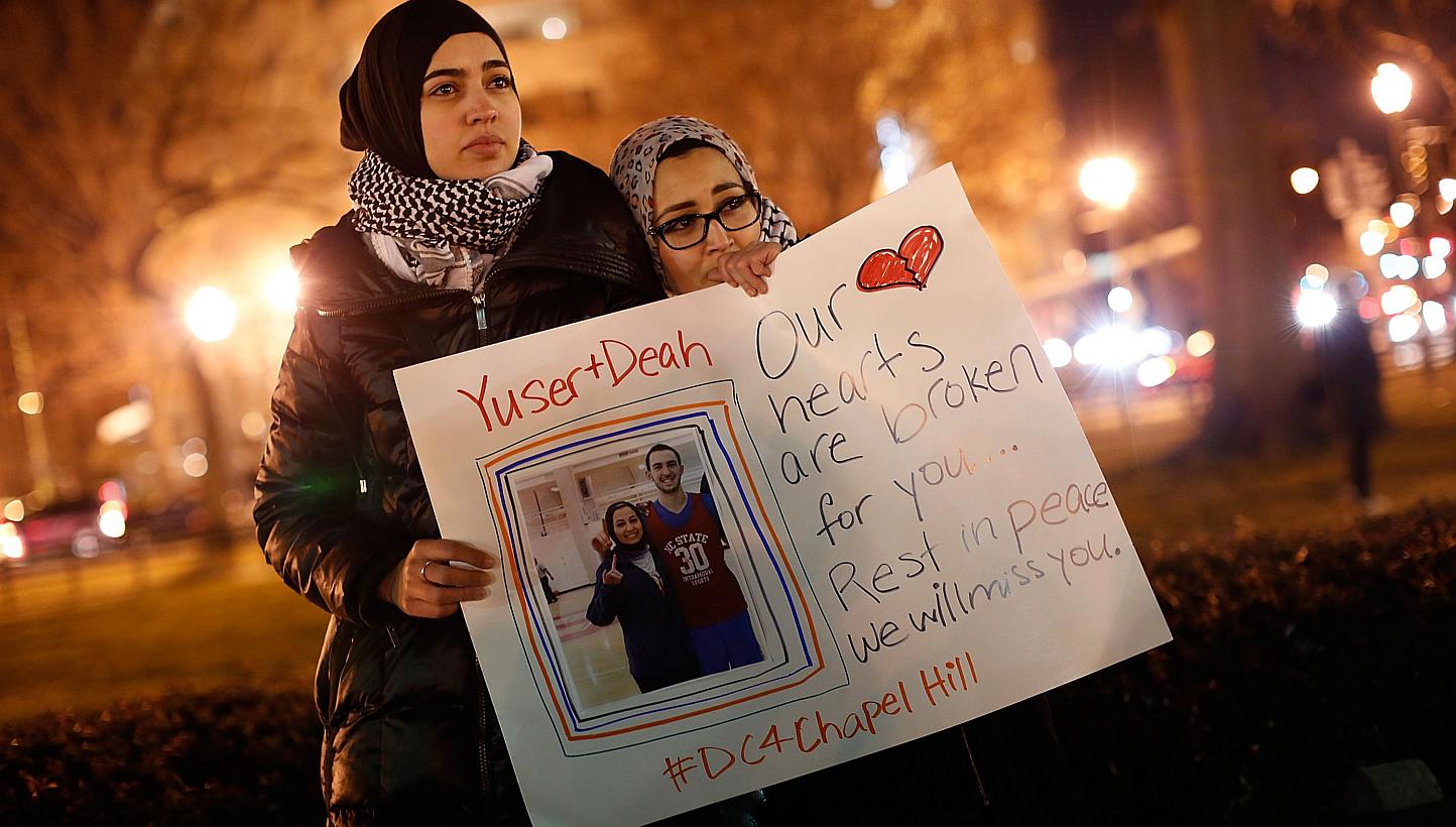 Kheira Benkreira (left) and Hasnia Bekkadja attend a vigil held by the Council on American-Islamic Relations in Dupont Circle in Washington, DC on Feb 12, 2015. -- PHOTO: AFP