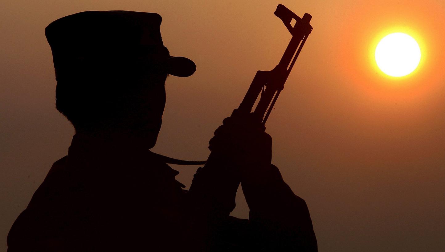 A file picture showing a Shan State Army soldier (SSA) silhouetted against the sun. The country's national army launched fresh air atrikes against rebels in the north on Feb 14, 2015. -- PHOTO: EPA