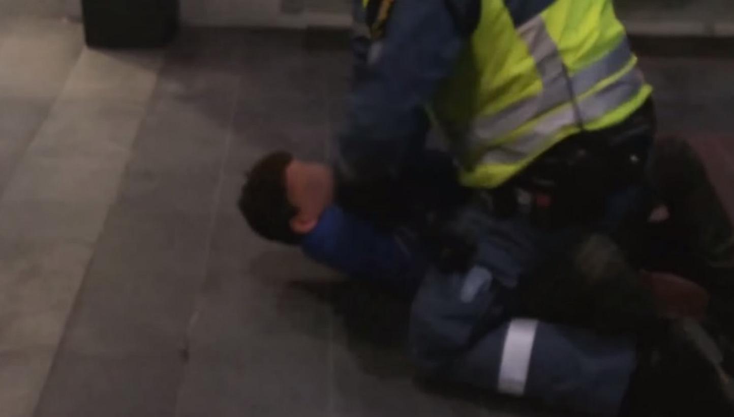 A screenshot from online footage of the incident in Malmoe central station. Video footage of a Moroccan boy begging for mercy as a security guard bangs his head against a brick floor has shocked Sweden as the country grapples with a record
