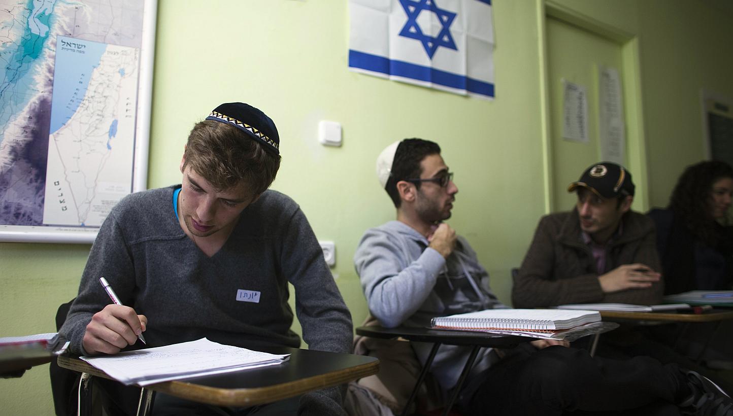 Newly arrived immigrants from France (from left) Jonathan Arbibe and Samuel Chemama and Alexandre Pequito study Hebrew at Ulpan Etzion, in Jerusalem on Jan 20, 2015.&nbsp;French Prime Minister Manuel Valls on Monday, Feb 16, 2015, urged France's Jews