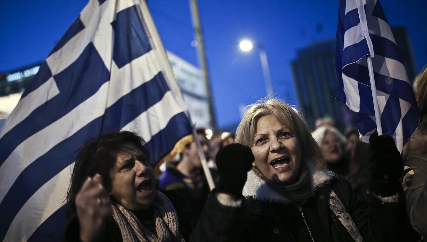 People shout slogans and wave Greek flags during an anti-austerity, pro-government rally in front of the Greek Parliament in Athens on February 15, 2015. -- PHOTO: AFP