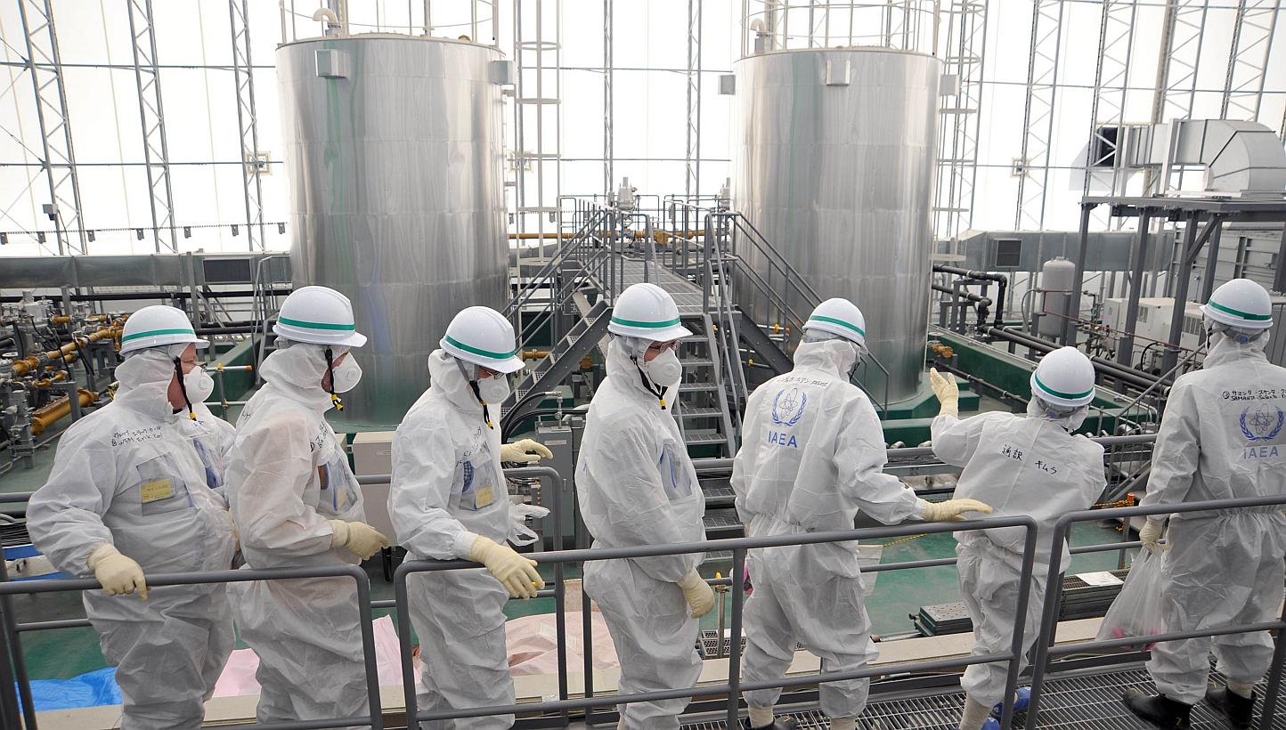 This handout picture released by International Atomic Energy Agency (IAEA) on Feb 17, 2015, shows IAEA mission team members inspecting TEPCO's Fukushima Daiichi Nuclear Power Station in Okuma, Fukushima prefecture. International advisers to Japa